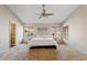 Spacious main bedroom with a ceiling fan, plush carpeting, and natural light from multiple windows at 4514 E Mazatzal Dr, Cave Creek, AZ 85331