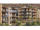 Multi-story condo with spacious balconies offering scenic views, complemented by lush greenery at 5000 N Camelback Ridge Dr # 304, Scottsdale, AZ 85251