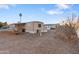 Mobile home with gravel landscaping, a small patio area and palm tree in the background at 535 S Alma School Rd # 60, Mesa, AZ 85210