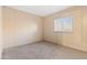 A bedroom with neutral walls and carpet flooring with a window for natural light at 535 S Alma School Rd # 60, Mesa, AZ 85210