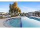 Wide view of community pool with access steps, lounge chairs and shade at 535 S Alma School Rd # 60, Mesa, AZ 85210