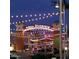 Nighttime view of Mesa Riverview's entertainment district, illuminated with festive string lights at 535 S Alma School Rd # 60, Mesa, AZ 85210