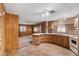 A kitchen with wood cabinets and tile backsplash that opens into the living area at 535 S Alma School Rd # 60, Mesa, AZ 85210