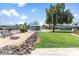 Community recreation area featuring a horseshoe pit, grass lawn, benches and mature landscaping at 535 S Alma School Rd # 60, Mesa, AZ 85210