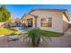 Exterior view of home featuring an inviting backyard patio and landscaped yard at 6442 W Cavedale Dr, Phoenix, AZ 85083