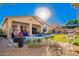 Lush backyard with covered patio and desert landscaping at 6442 W Cavedale Dr, Phoenix, AZ 85083