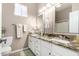 Bright bathroom featuring a double vanity with granite countertops and white cabinetry at 6442 W Cavedale Dr, Phoenix, AZ 85083