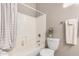 Bright bathroom featuring a white tiled shower-tub combination at 6442 W Cavedale Dr, Phoenix, AZ 85083