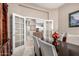 Formal dining room featuring neutral walls, elegant lighting, and views into the kitchen at 6442 W Cavedale Dr, Phoenix, AZ 85083