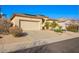 Single-story home with a two-car garage, neutral exterior, desert landscaping, and solar panels at 6442 W Cavedale Dr, Phoenix, AZ 85083