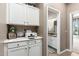 Hallway with white cabinets and an open doorway leading to bathroom at 6442 W Cavedale Dr, Phoenix, AZ 85083