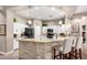 Modern kitchen showcasing a breakfast bar, stainless steel appliances, and ample counter space at 6442 W Cavedale Dr, Phoenix, AZ 85083