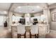 Modern kitchen featuring a breakfast bar with stone accents and white cabinetry at 6442 W Cavedale Dr, Phoenix, AZ 85083