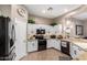 Well-lit kitchen featuring white cabinetry, granite countertops, and modern appliances at 6442 W Cavedale Dr, Phoenix, AZ 85083