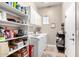 Laundry room with modern washer and dryer, storage shelves, and natural light at 6442 W Cavedale Dr, Phoenix, AZ 85083