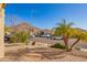 A street view in a desert community showing the houses and natural vegetation at 6442 W Cavedale Dr, Phoenix, AZ 85083