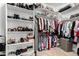 Organized walk-in closet with shelves and rods for clothing and shoe storage at 6442 W Cavedale Dr, Phoenix, AZ 85083