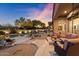 Outdoor seating area next to a sparkling pool, complete with mature desert landscaping at 6626 E Oberlin Way, Scottsdale, AZ 85266