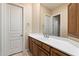 Bright bathroom with a vanity, mirror, and a door leading to another room at 6626 E Oberlin Way, Scottsdale, AZ 85266