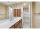 Bathroom with white countertop vanity, dual doors to shower and hallway, and neutral paint at 6626 E Oberlin Way, Scottsdale, AZ 85266