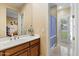 Bathroom with double sinks, wood cabinets, tile flooring and shower area at 6626 E Oberlin Way, Scottsdale, AZ 85266