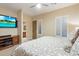 Bedroom with TV, shuttered windows, and attached bathroom at 6626 E Oberlin Way, Scottsdale, AZ 85266