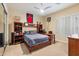 A bedroom with a double bed, ceiling fan and desk with shelves at 6626 E Oberlin Way, Scottsdale, AZ 85266