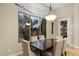 Light-filled dining room with contemporary chandelier and large windows at 6626 E Oberlin Way, Scottsdale, AZ 85266