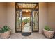 Ornate ironwork front doors open to a bright living space at 6626 E Oberlin Way, Scottsdale, AZ 85266