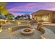 Inviting backyard fire pit with built in seating and professional landscaping at 6626 E Oberlin Way, Scottsdale, AZ 85266