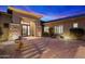 Elegant home exterior featuring a fountain, desert landscaping, and ironwork door at 6626 E Oberlin Way, Scottsdale, AZ 85266