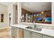 Modern kitchen with stainless steel appliances, white countertops, and an open view to the living area at 6626 E Oberlin Way, Scottsdale, AZ 85266