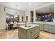 Open kitchen with a large center island, stainless steel sink, and seamless view to the breakfast nook at 6626 E Oberlin Way, Scottsdale, AZ 85266