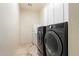 Laundry room with washer, dryer, and white cabinets at 6626 E Oberlin Way, Scottsdale, AZ 85266