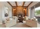 Comfortable living room featuring a stone fireplace, wooden beams and seating area at 6626 E Oberlin Way, Scottsdale, AZ 85266