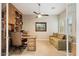 Home office with built-in shelving, a large desk, comfortable seating, and natural light at 6626 E Oberlin Way, Scottsdale, AZ 85266