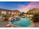 Inviting pool with a stone surround, water feature, and outdoor seating for relaxation and enjoyment at 6626 E Oberlin Way, Scottsdale, AZ 85266