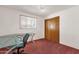 Bright bedroom with a large window, desk, and closet provides ample space for comfort and productivity at 6934 E Coronado Rd, Scottsdale, AZ 85257