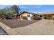 Charming single-story home with a rock yard, covered carport and white painted brick at 6934 E Coronado Rd, Scottsdale, AZ 85257