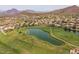 Scenic aerial view of the golf course community with lush greenery and mountain views at 7149 E Quartz St, Mesa, AZ 85207