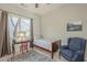 Well-lit bedroom with window, wood furniture, rug, and comfortable seating at 7149 E Quartz St, Mesa, AZ 85207