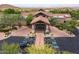 The community entrance showcasing manicured landscaping, covered entrance, and ample parking for an inviting first impression at 7149 E Quartz St, Mesa, AZ 85207