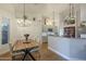 Elegant dining area adjacent to kitchen, featuring stylish lighting and wood floors for cozy meals at 7149 E Quartz St, Mesa, AZ 85207