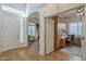 Welcoming foyer boasts wood floors, arched doorway, and office access, creating a functional entrance at 7149 E Quartz St, Mesa, AZ 85207