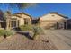 Charming single-story home with desert landscaping, stone accents, and three-car garage at 7149 E Quartz St, Mesa, AZ 85207