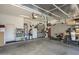 Spacious garage with ample storage, tall ceilings and epoxy flooring is perfect for a workshop or hobby area at 7149 E Quartz St, Mesa, AZ 85207