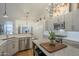 Contemporary kitchen showcasing sleek gray cabinets, stainless appliances, and stylish hardwood floors at 7149 E Quartz St, Mesa, AZ 85207