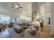 Bright living room featuring hardwood floors, neutral walls, stylish furniture, and outdoor access at 7149 E Quartz St, Mesa, AZ 85207