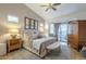 Inviting main bedroom features a ceiling fan, natural light, and access to the backyard at 7149 E Quartz St, Mesa, AZ 85207