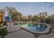 Backyard pool surrounded by desert landscaping, with multiple seating areas and a tranquil ambiance for outdoor relaxation at 7149 E Quartz St, Mesa, AZ 85207